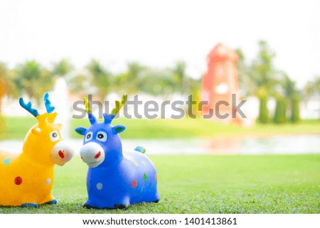 Toy horse in a summer park. Copy space. Selective focus. 