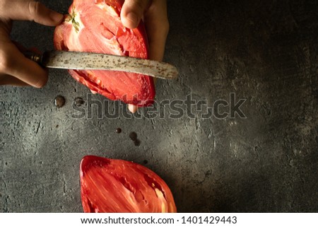 Hands Cutting Organic Bull's Heart Heirloom Tomato. Superfood Healthy Eating Concept.