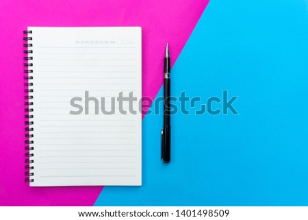 Top view blank notebook and black pen for mockup flat lay on blue and pink background. 