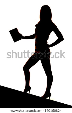 A silhouette of a woman holding on to one book.
