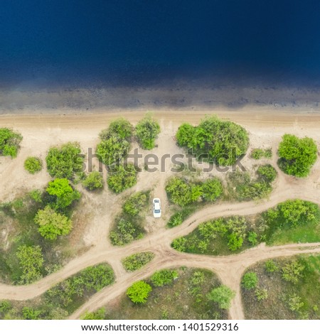 Top view aerial image from drone of an stunning beautiful river landscape beach with blue water.
