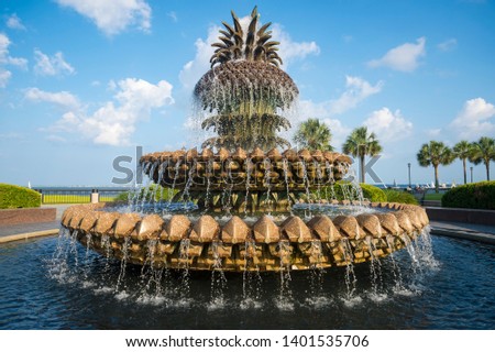 
Scenic view of water streaming from a fountain in the shape of a pineapple on a blue sky afternoon at the waterfront in Charleston, South Carolina, USA