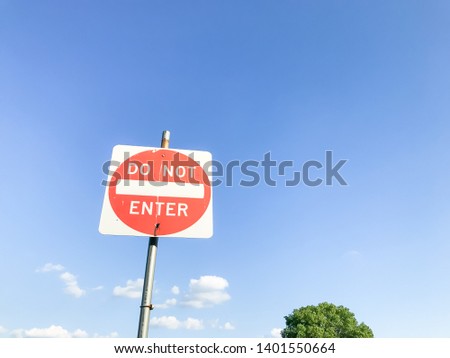 Do not enter sign again cloud blue sky with trees top at the park