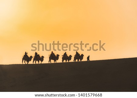 Camels Walking in the Desert Royalty-Free Stock Photo #1401579668