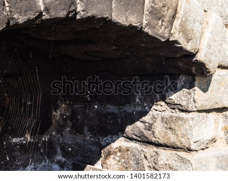 Outside Fireplace. Stone oven.  Close up of Traditional stone oven. Grey stone texture. Spider web close up.
