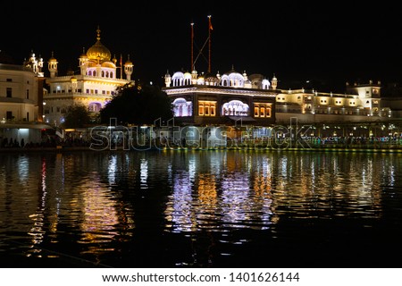 Golden temple (Harmandir sahib) in Amritsar at night.
The text on the photo is on Punjabi, this is the sikh prayer or shabd: Dhan Dhan Sri Guru Ram Das Ji. And means "Blessed, blessed is Guru Ram Das"