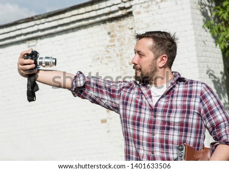 A man takes a selfie on the camera