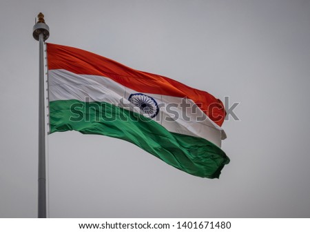 Waving Image of indian national flag with sky background is shown. This is the national flag of the biggest democratic country india.