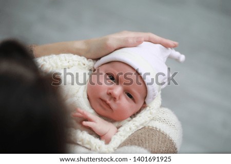 Baby newborn sleeping wrapped up in a warm blanket
