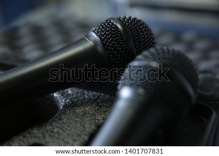  black microphone on gray background in soft focus blur