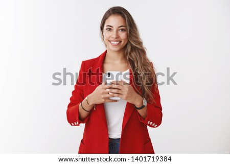 Portrait gorgeous confident stylish female wearing red jacket asking take picture holding smartphone smiling broadly like taking selfie mirror looking good outfit, posting images online
