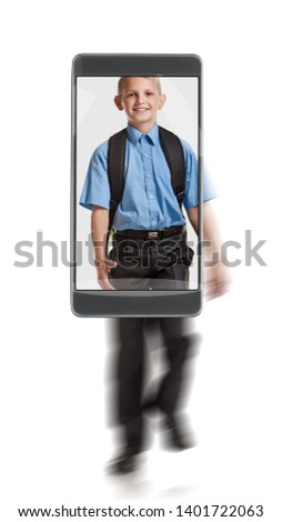 Portrait of young happy smiling blond schoolboy with knapsack. conceptual image with a smartphone, demonstration of device capabilities