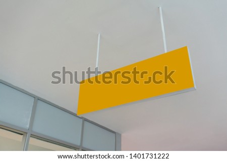 Blank yellow advertising ceiling Promotional Advertising dangler for design presentation. Directional sign.
