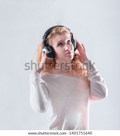young woman in headphones listening to music