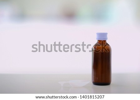 Glass drug bottles with white caps on blur background with copy space