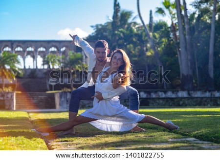 Young happy couple dancing in the summer park. Concept of happy date