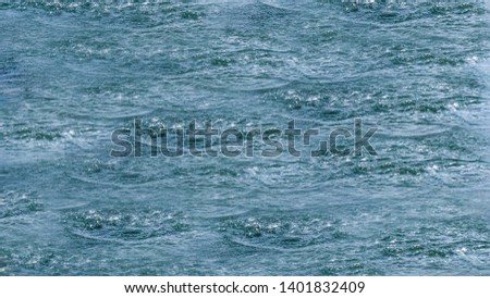 Ripples on sea abstract texture pattern background. Splashes, ripples, circles made by stones thrown into sea. Round droplets of clear water over circles. Fresh bright water drop, whirl, splash. 