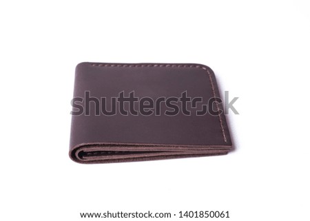 Brown handmade leather man wallet isolated on white background. Wallet is closed. Stock photo of luxury businessman accessories.