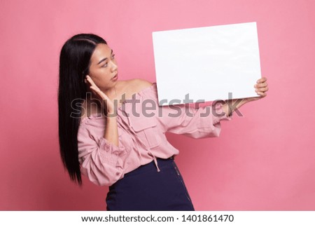 Young Asian woman  surprise with  white blank sign on pink background