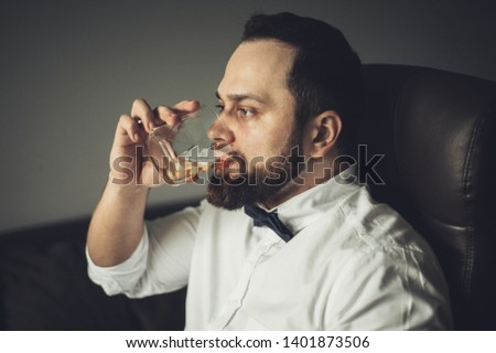 Close up of senior man with whiskey glass . 