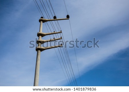 closeup electric post with wire on the blue sky background