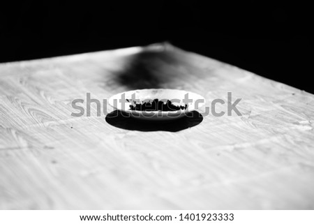 Picture of a circular rice dish / black background on an outdoor table.