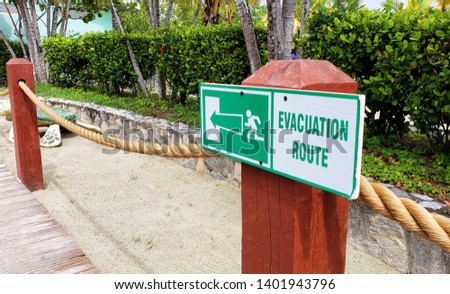 Evacuation Route green and white sign on a Caribbean beach