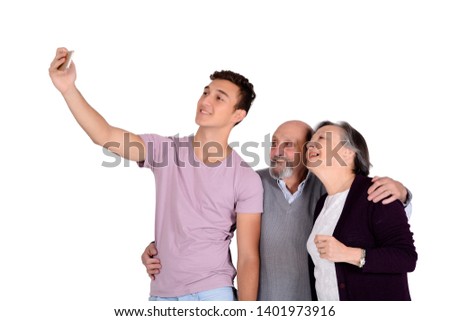 Grandparents and their teen grandson taking a selfie. Isolated on white background