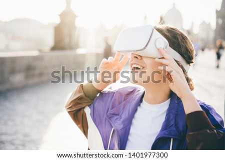 Woman wearing vr headset virtual reality in the history city center. Concept of virtual museum.  Royalty-Free Stock Photo #1401977300