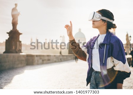 Woman wearing vr headset augmented virtual reality in history city center. Concept of virtual museum.  Royalty-Free Stock Photo #1401977303