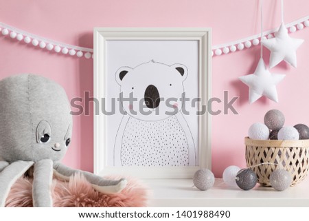 Modern scandinavian newborn baby room with white mock up poster frame, plush octopus, rattan basket with cotton balls. Cozy interior with pink walls. Haniging cotton garland and stars. Template

