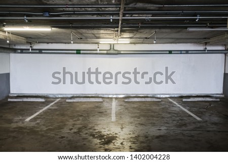 Parking garage department store interior with blank billboard.