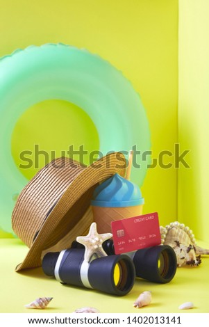 Financial travel plan concept, Composition traveler summer  vacations accessories retro binoculars ,Red Credit card and starfish  summertime on bright yellow wall background. copy space for banner