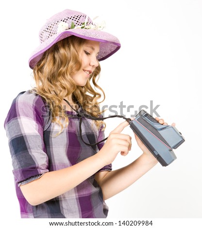 Smiling teenage girl holding a camera