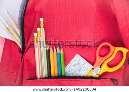 Top view Red bag backpack for education children on pink background back to school concept