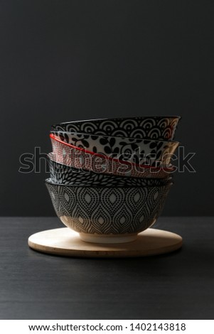 Bowls on black background. Ceramic bowl in different patterns stacked together.
