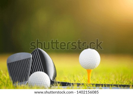 Golf balls and golf clubs as well as equipment used to play golf on green grass in a beautiful golf course. Sports that people around the world play during the holidays for health.