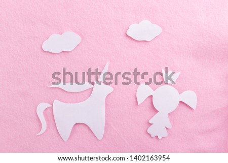 paper art of a unicorn on pink background