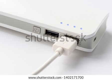 USB cable with USB wall charger plug on a white background. Portable charger close-up