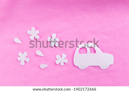 Girl driving car. paper art of a car on pink background