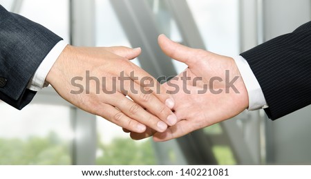 Male handshake isolated on business background