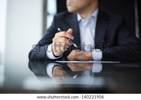 Close-up of male hands with pen Royalty-Free Stock Photo #140221906