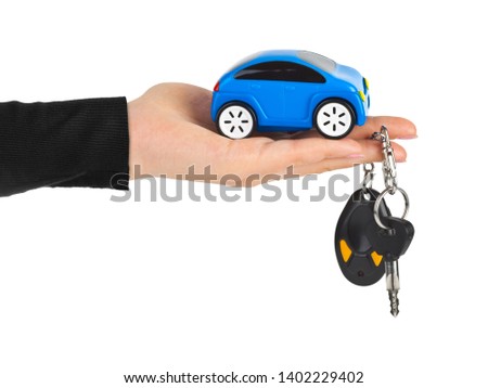 Hand with keys and car isolated on white background