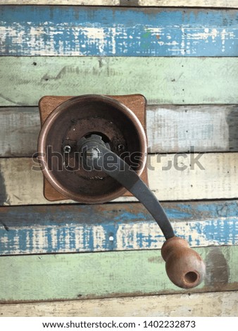 Old coffee grinder on Vintage table wood