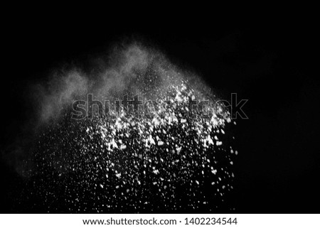 White powder explosion on black background. Colored cloud. Colorful dust explode. Paint Holi.

