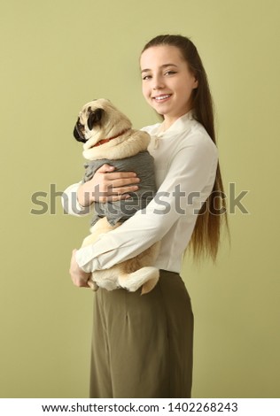 Teenage artist with cute pug dog at home