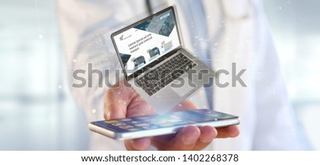 View of a Doctor holding a Laptop with business website template on the screen isolated on a background