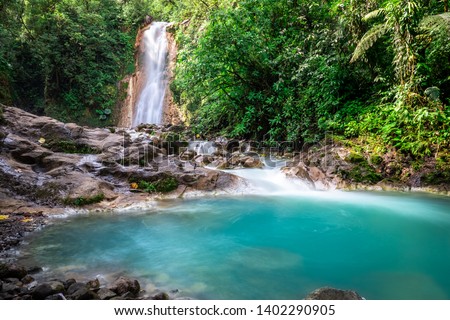 Blue falls of Costa Rica, natural landscape at Bajos del Toro close to the Catarata del Toro and San Jose. Photo taken at slow shutter speed and with ND filter. Smooth waterfall. 