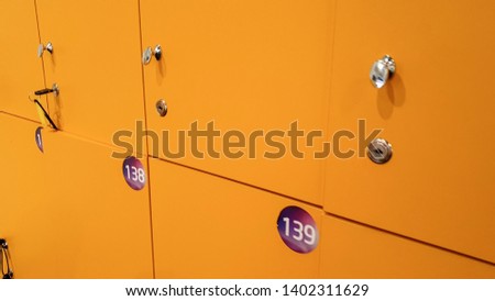 CLoseup photo of straight long rows of yellow lockers in the school or college