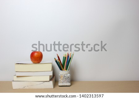 Back to school concept. Book clock and pencil on isolated white background. Copy space.